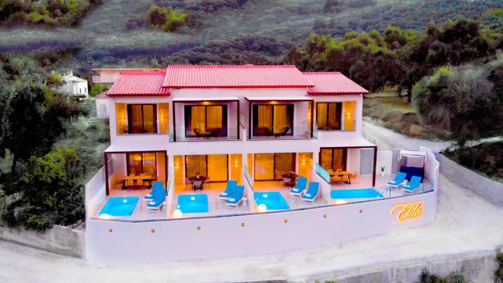 una vista aérea de una casa con sillas azules en Elite Luxury Villas, en Parga