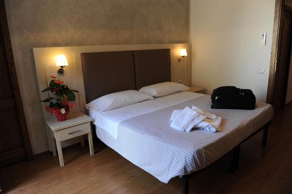A bed or beds in a room at Super Relais Stella