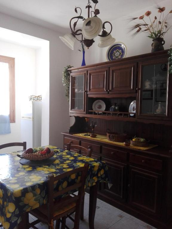 a kitchen with a table with a bowl of fruit on it at Casa della camperia in Favignana