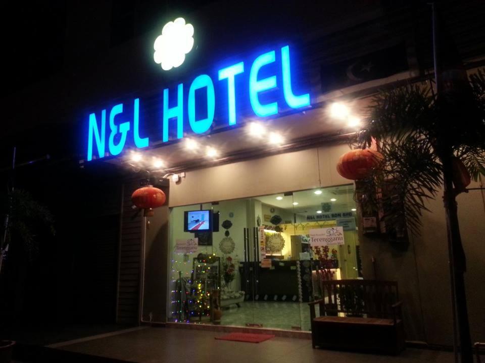 a neon sign for a neloped store at night at N&L HOTEL KUALA TERENGGANU in Kuala Terengganu