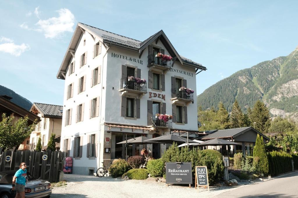a large white building with flowers on the windows at Eden Hotel, Apartments and Chalet Chamonix Les Praz in Chamonix-Mont-Blanc