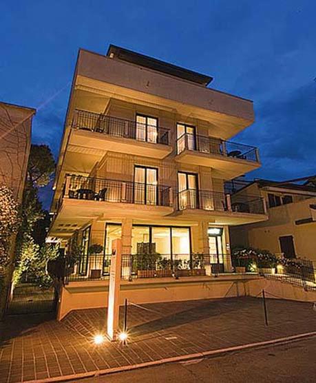 a large apartment building with lights on the side of it at Residence Ascot in Cattolica