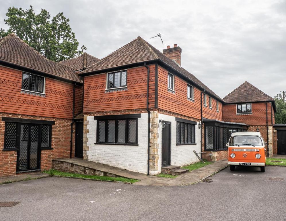 an orange van parked in front of a brick house at 2 Ringles Place in Uckfield