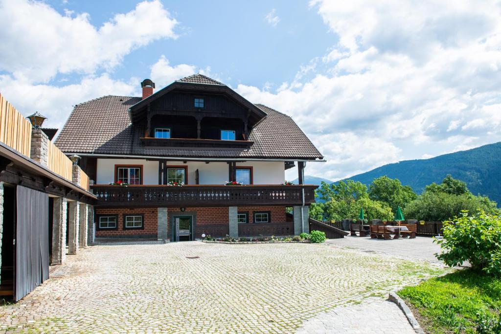 a large house with a roof on top of it at Hansbauer Appartments in Gmünd in Kärnten
