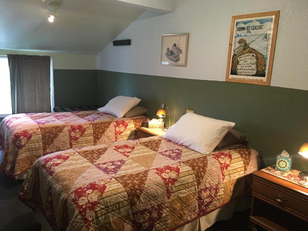 a hotel room with two beds and a window at FireWeed RoadHouse in Nenana