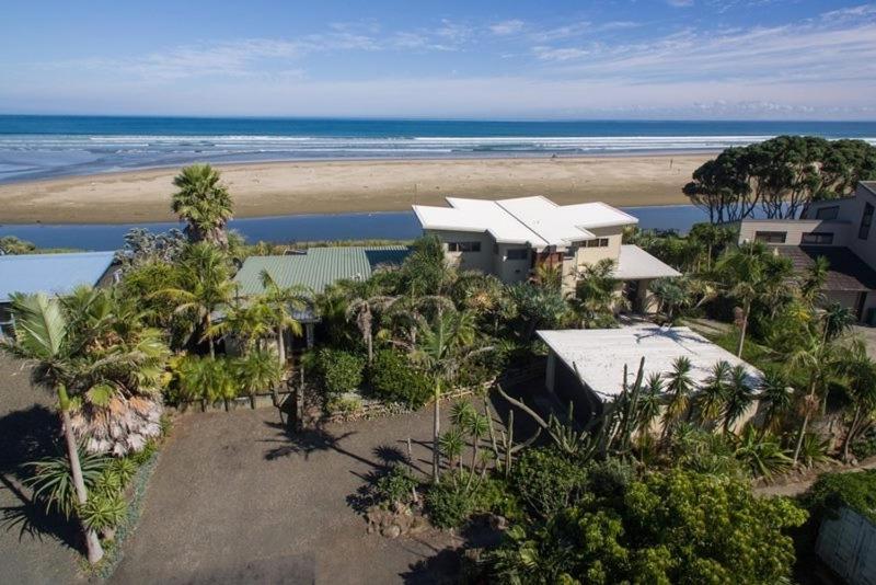 an aerial view of a house and the beach at Gems Seaside Lodge in Ahipara