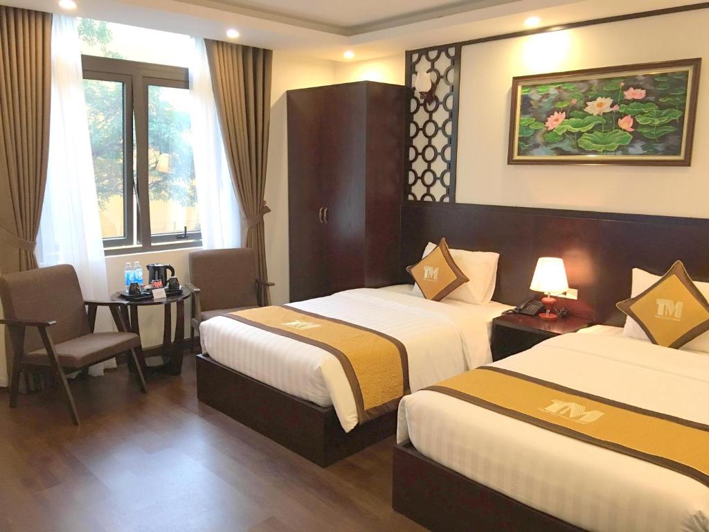 Postel nebo postele na pokoji v ubytování T&M Luxury Hotel Hanoi