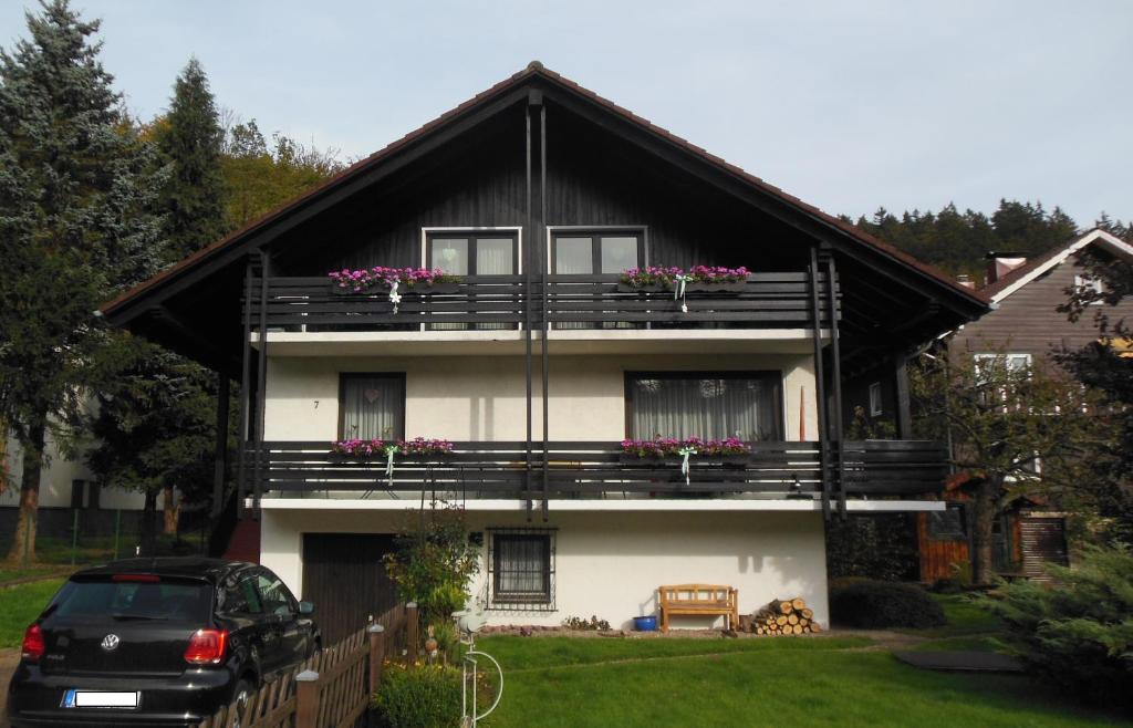 a house with a balcony with flowers on it at Landhaus Kathrin in Walkenried