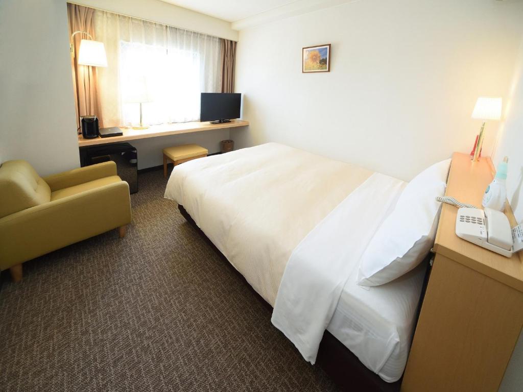 Postel nebo postele na pokoji v ubytování Hotel Route Tsukuba