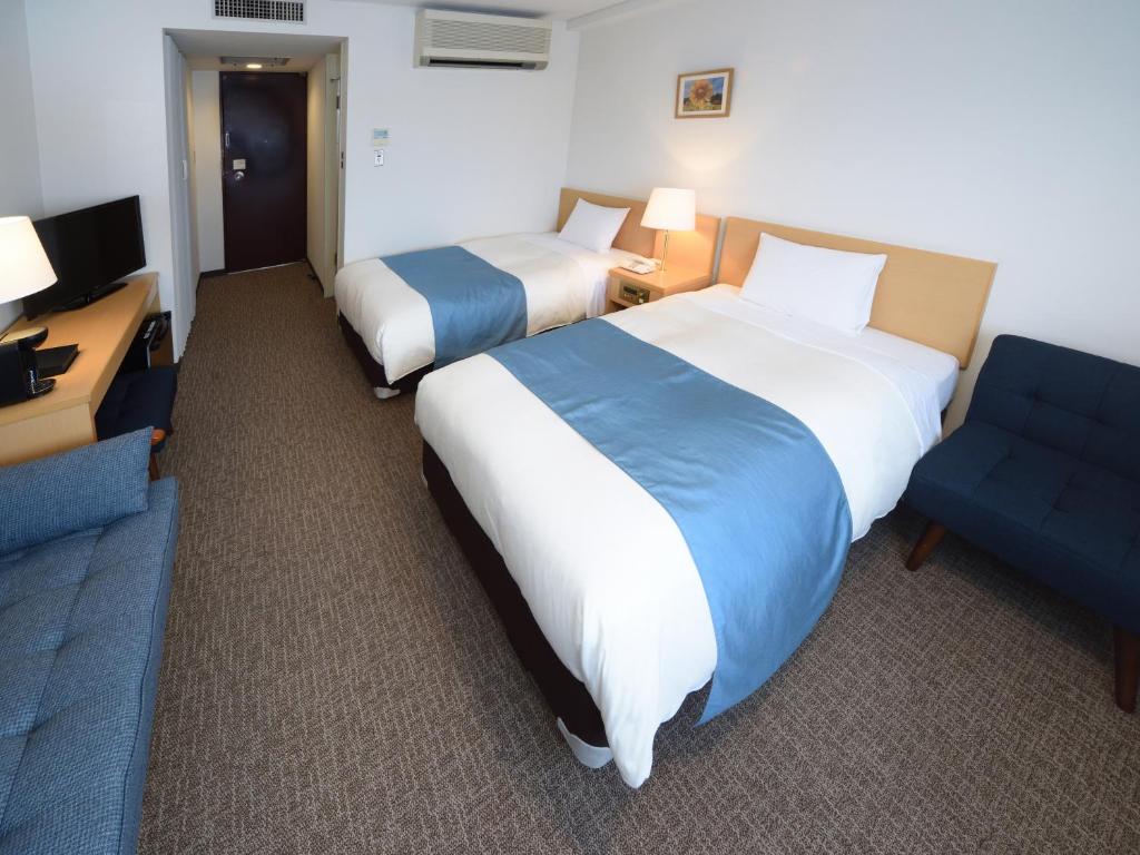 Postel nebo postele na pokoji v ubytování Hotel Route Tsukuba