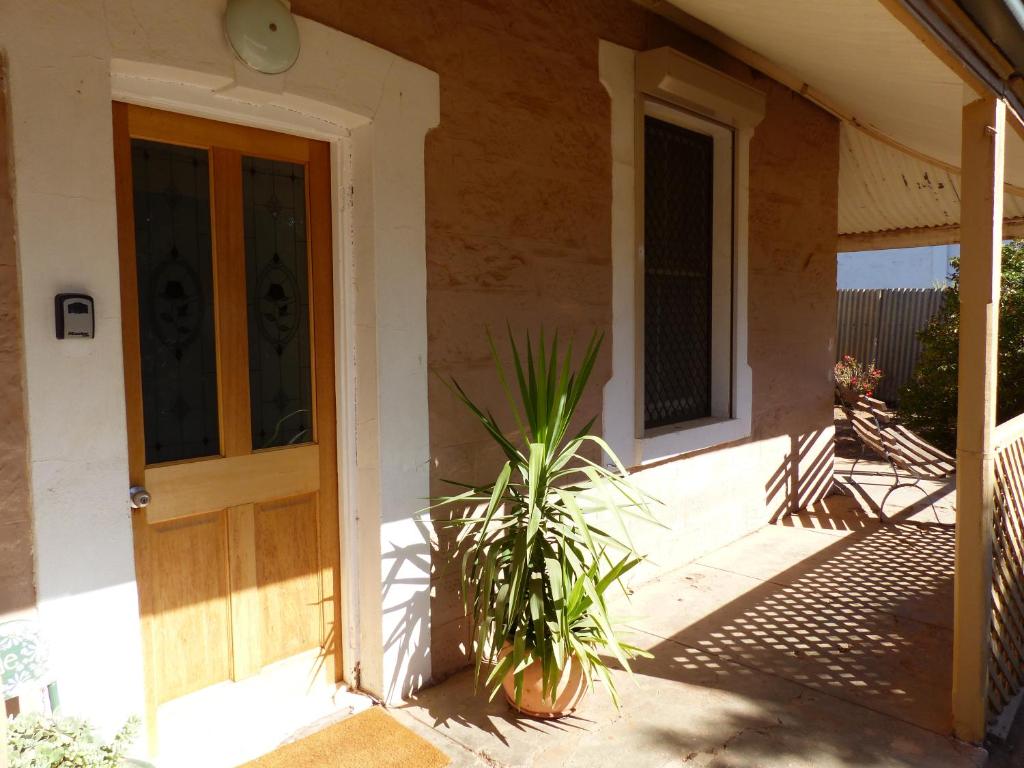 a house with a plant in front of a door at Andy's Accommodation in Peterborough