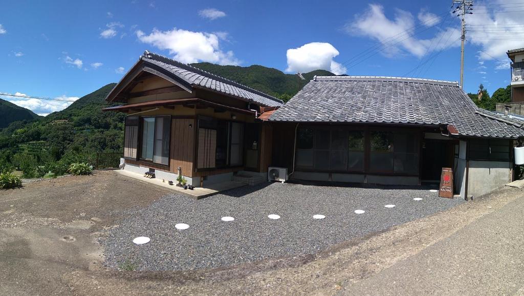 una casa con mucha grava delante de ella en Kumano Kodo Nagano Guesthouse en Tanabe