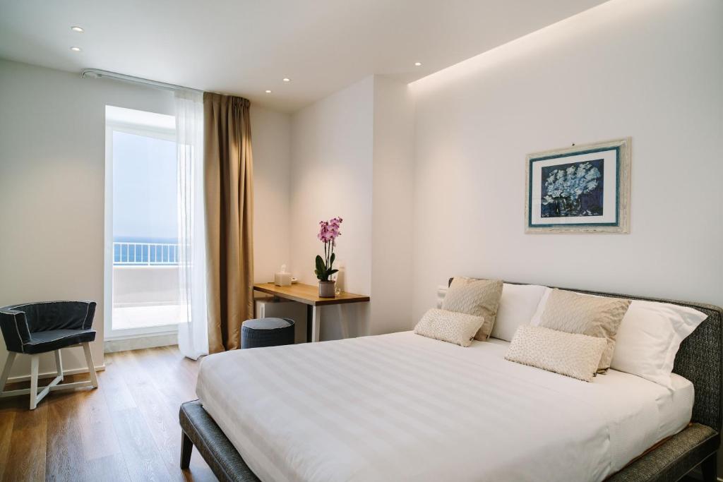 Postel nebo postele na pokoji v ubytování NUMA HOTEL
