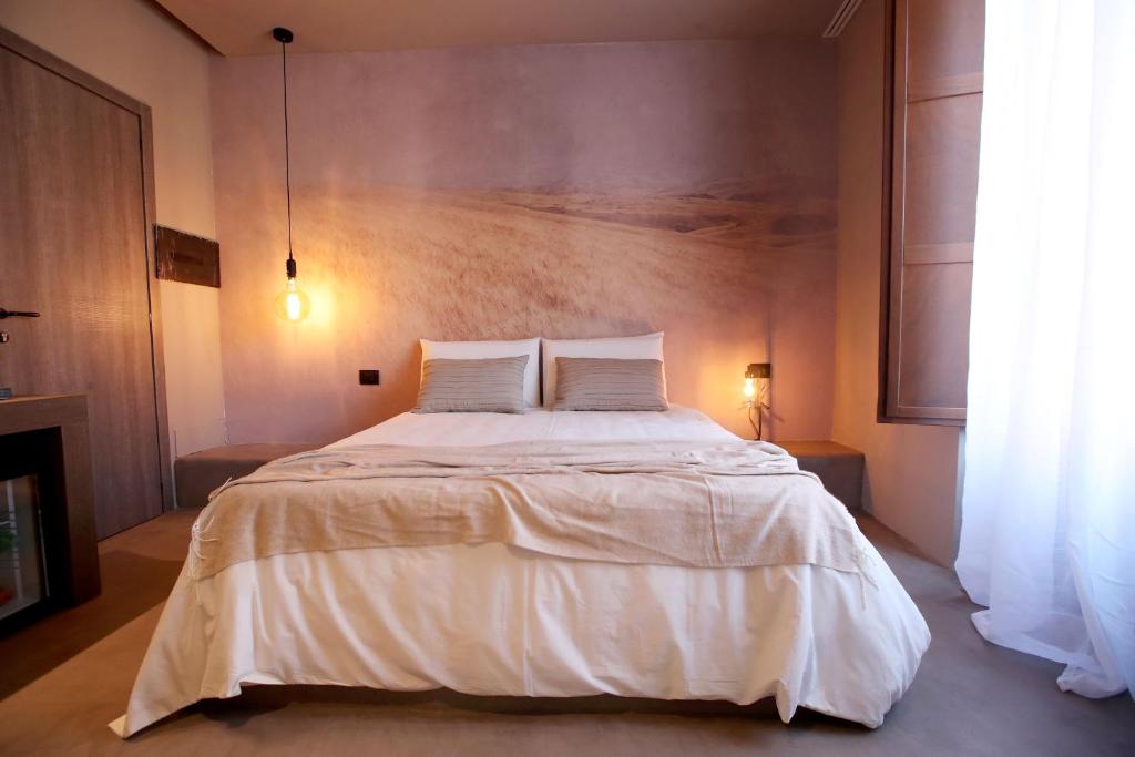 Postel nebo postele na pokoji v ubytování Casa Nostra Luxury Suites & Spa