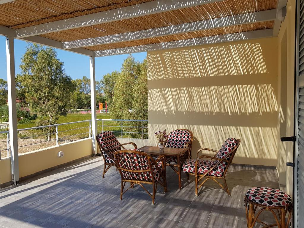 a patio with a table and chairs on a deck at Xi House in Xi