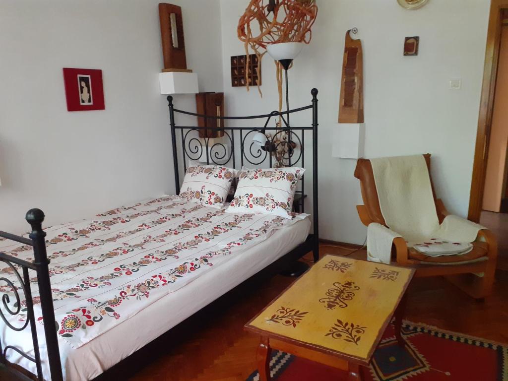 a bedroom with a bed and a chair at Apartament Anca in Timişoara