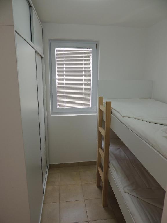 Un pat sau paturi într-o cameră la Apartment Šušanj