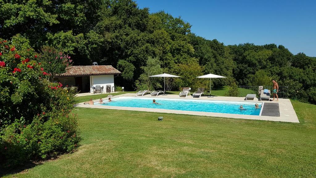 a swimming pool in a yard next to a house at Maison d hotes Lapitxuri in Arcangues
