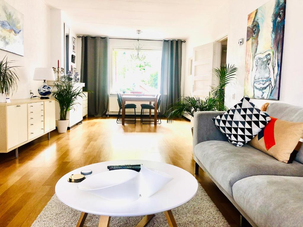 a living room with a couch and a table at Light and Spacious Getaway House in Arnhem