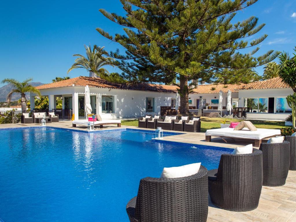 a swimming pool in front of a villa at Villa Issabella in Marbella