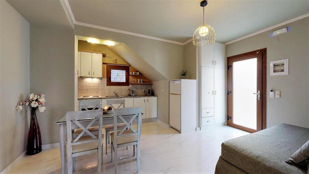 a small kitchen with a table in a room at Parga Inn Suites in Parga