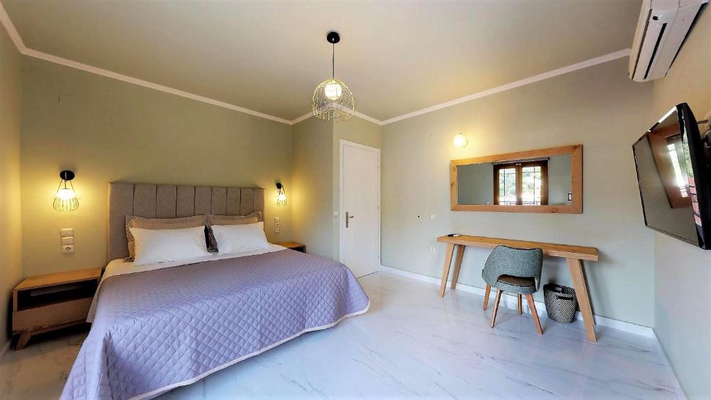 a bedroom with a bed and a desk and a tv at Parga Inn Suites in Parga