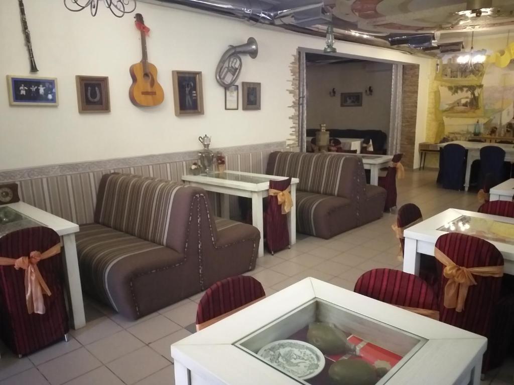 a waiting room with couches and a guitar on the wall at Fiesta in Bilhorod-Dnistrovskyi