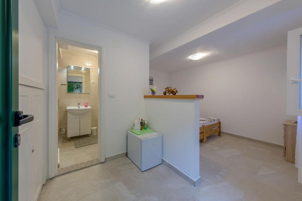 a bathroom with a sink and a toilet in a room at Room Nino in Skradin