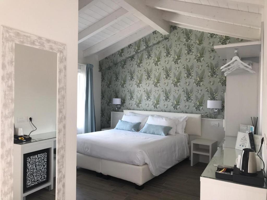 A bed or beds in a room at CASA BACI - Soggiorno nel Gusto