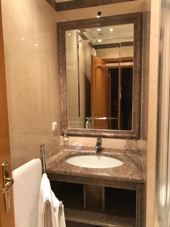 a bathroom with a sink and a mirror at Atlantic Waves Accommodation in Carcavelos