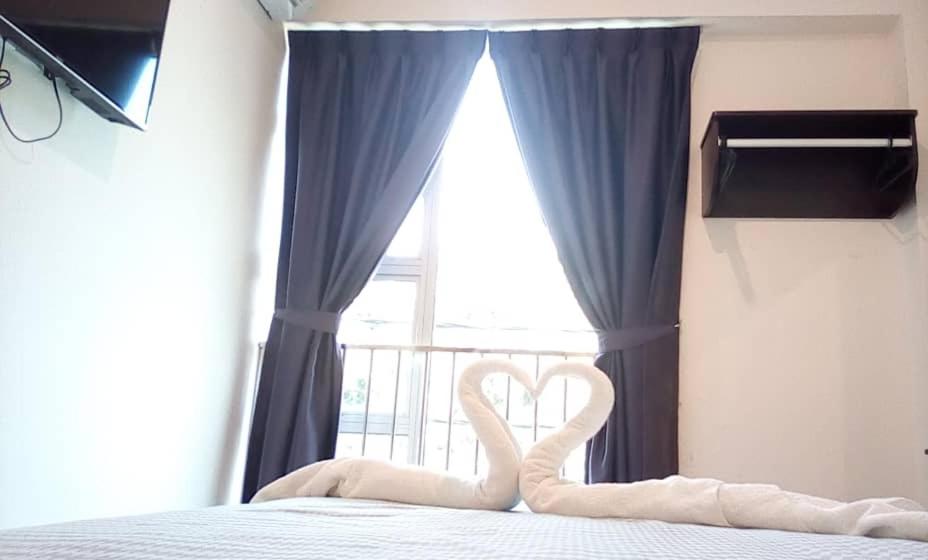 Postel nebo postele na pokoji v ubytování Hotel Pangkor SJ