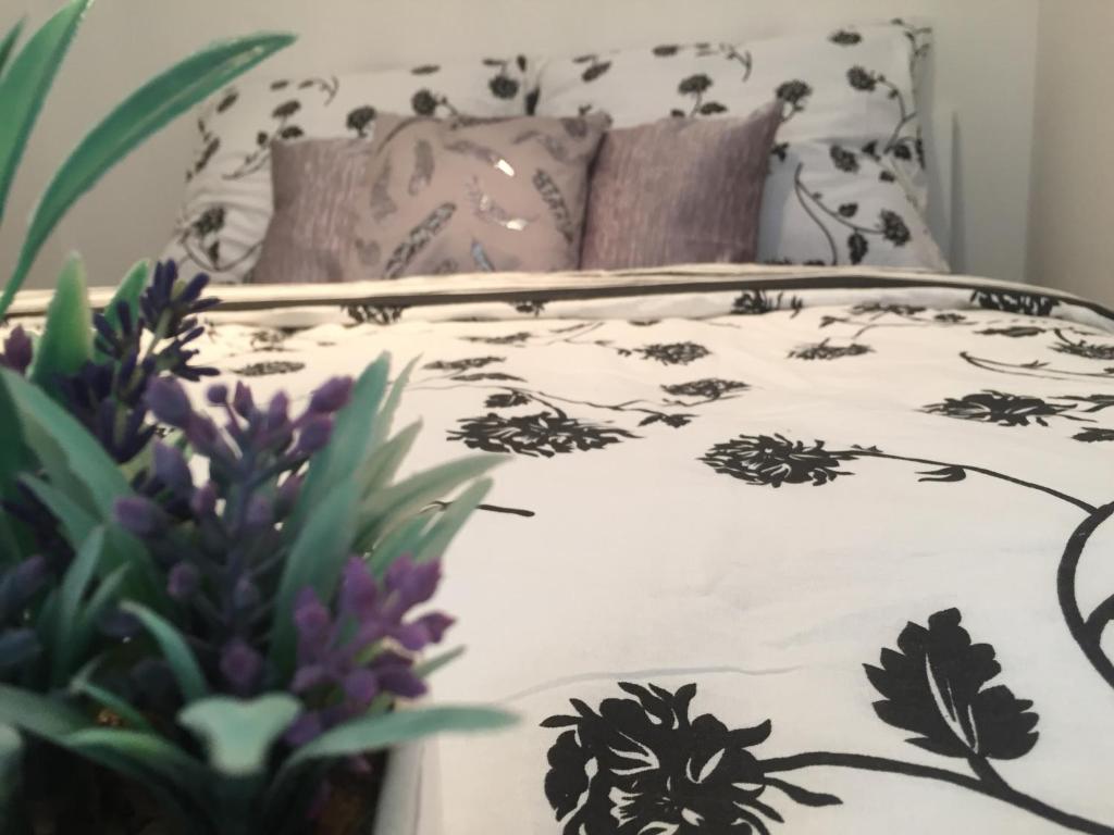 a bed with a black and white comforter and pillows at Apartments U Flóry in Olomouc