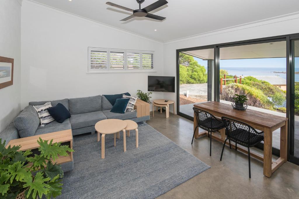 a living room with a couch and a table at FortyTwo Mini in Gracetown