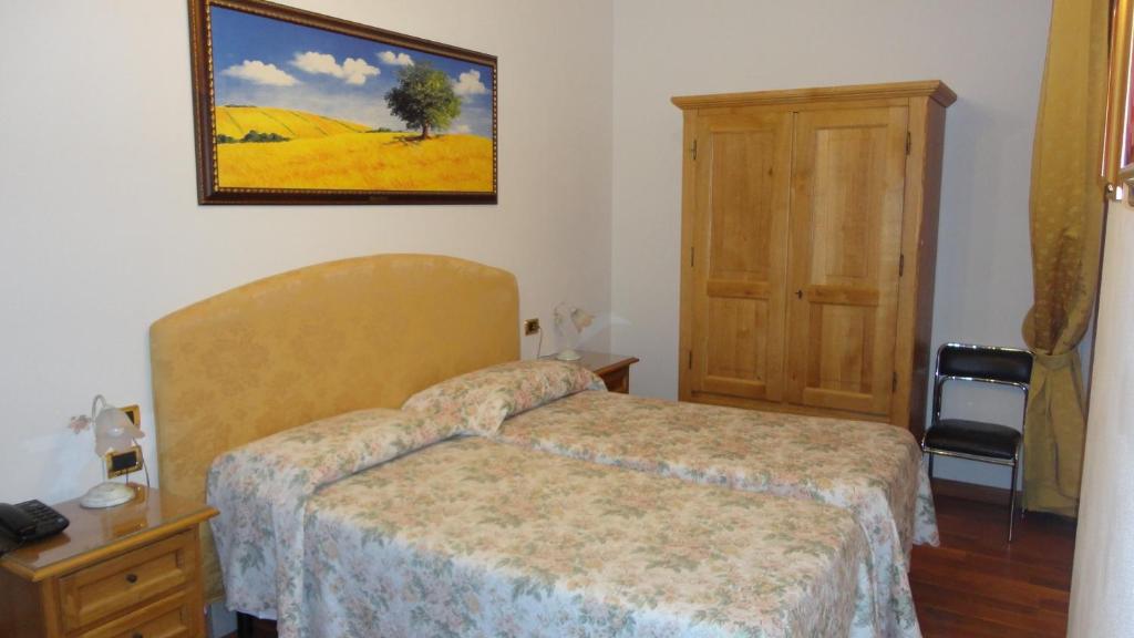 Postel nebo postele na pokoji v ubytování Hotel La Rosa