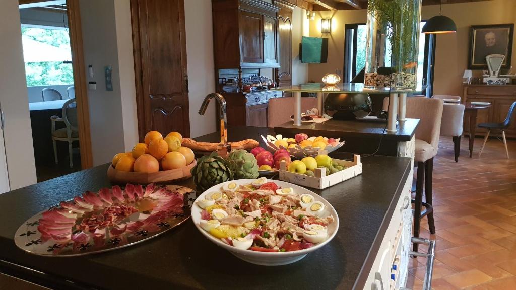 a bunch of fruits and vegetables on a kitchen counter at Maison d hotes Lapitxuri in Arcangues