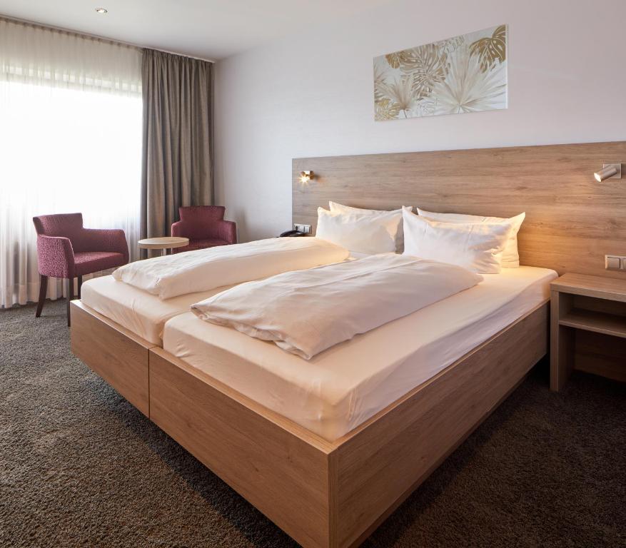 Postel nebo postele na pokoji v ubytování NaturKulturHotel Stumpf