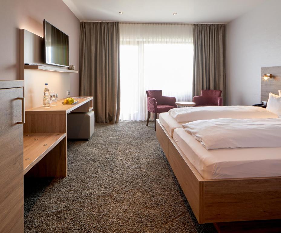 Postel nebo postele na pokoji v ubytování NaturKulturHotel Stumpf