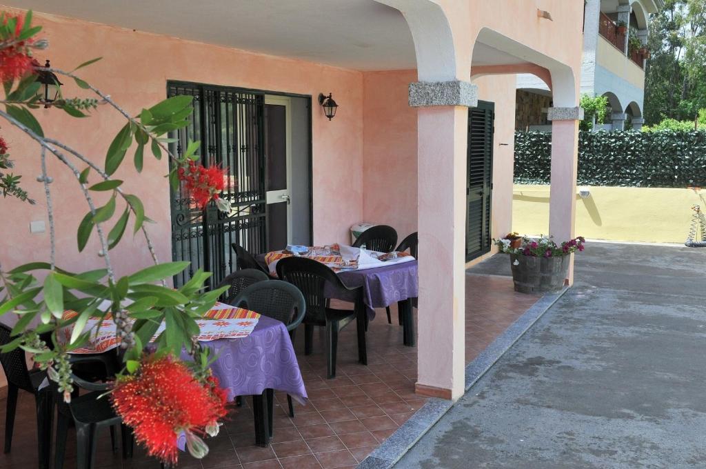 a patio with tables and chairs in a house at Affittacamere Da Antonella in Posada