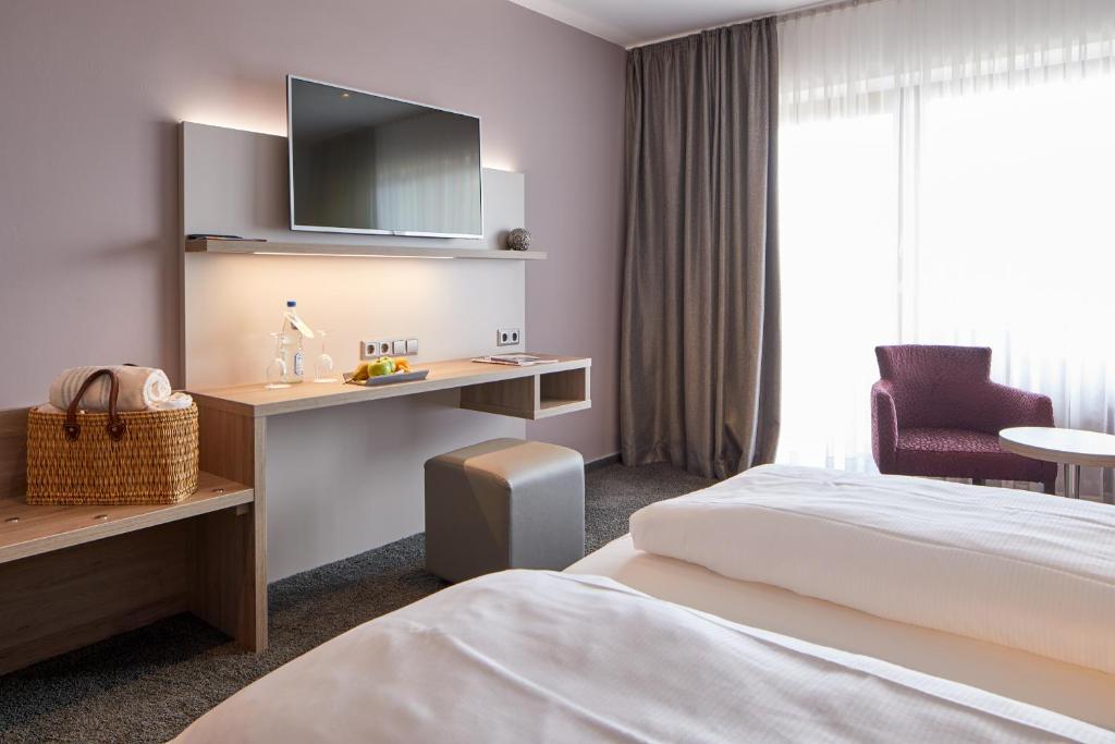 Postel nebo postele na pokoji v ubytování NaturKulturHotel Stumpf