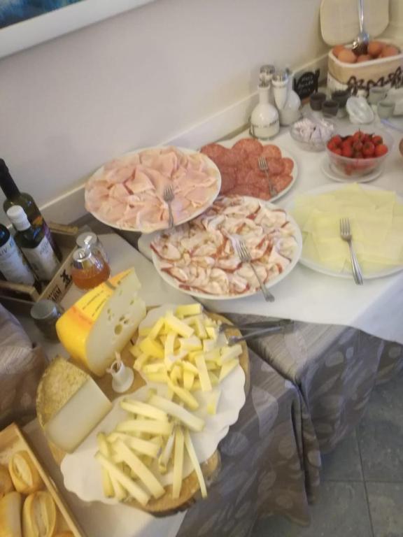 a table with many different types of food on it at Hotel Turandot in Torre del Lago Puccini
