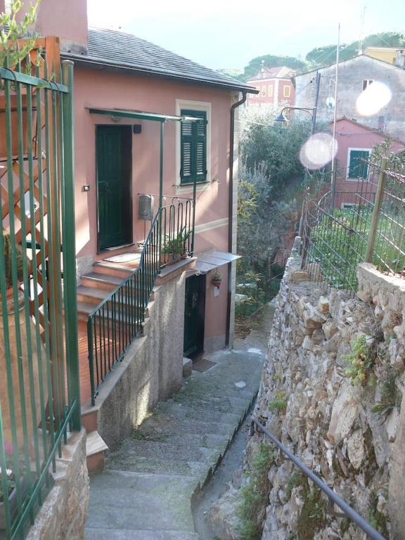 a small house with a porch and a stone wall at Ca' di Ro in Camogli