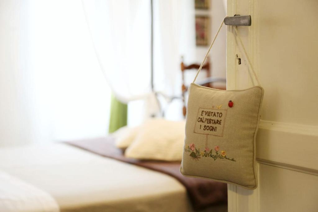 a bag hanging on a wall next to a bed at Ca' di Ro in Camogli