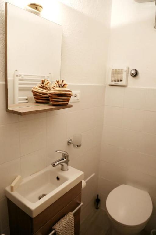 a bathroom with a sink and a toilet and a mirror at Ca' di Ro in Camogli