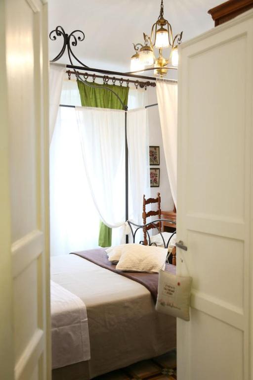 a bedroom with a bed with a window and a chandelier at Ca' di Ro in Camogli