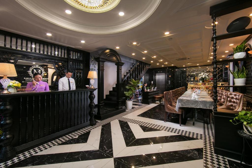 a lobby of a restaurant with a bar at Madelise Central Hotel & Travel in Hanoi