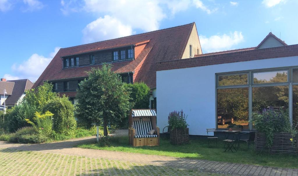 a house with a large white garage at Hotel-Pension Seeadler in Prerow