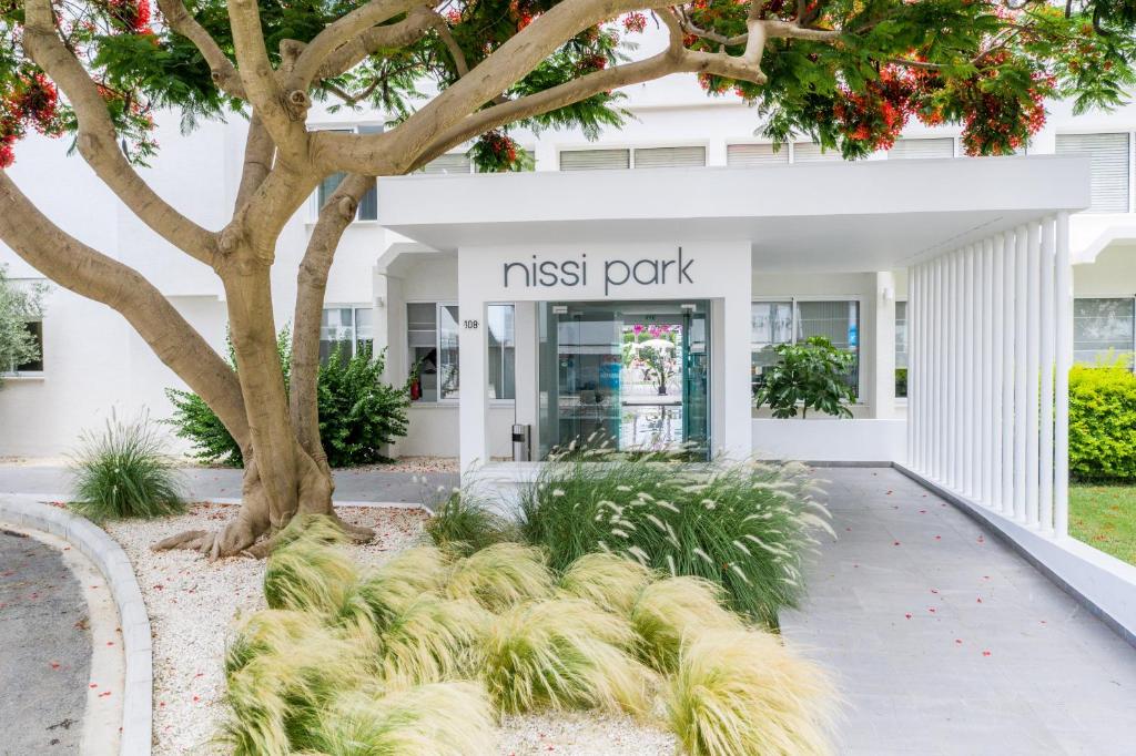 a building with a sign that reads nest park at Nissi Park Hotel in Ayia Napa