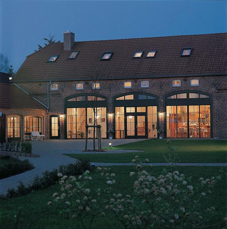 a large brick building with large glass windows at Ferienpark Mecklenburg in Ziegendorf