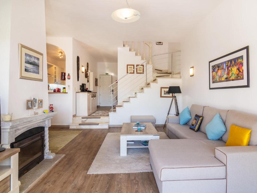a living room with a couch and a fireplace at Holiday Home Roberts by Interhome in Albufeira