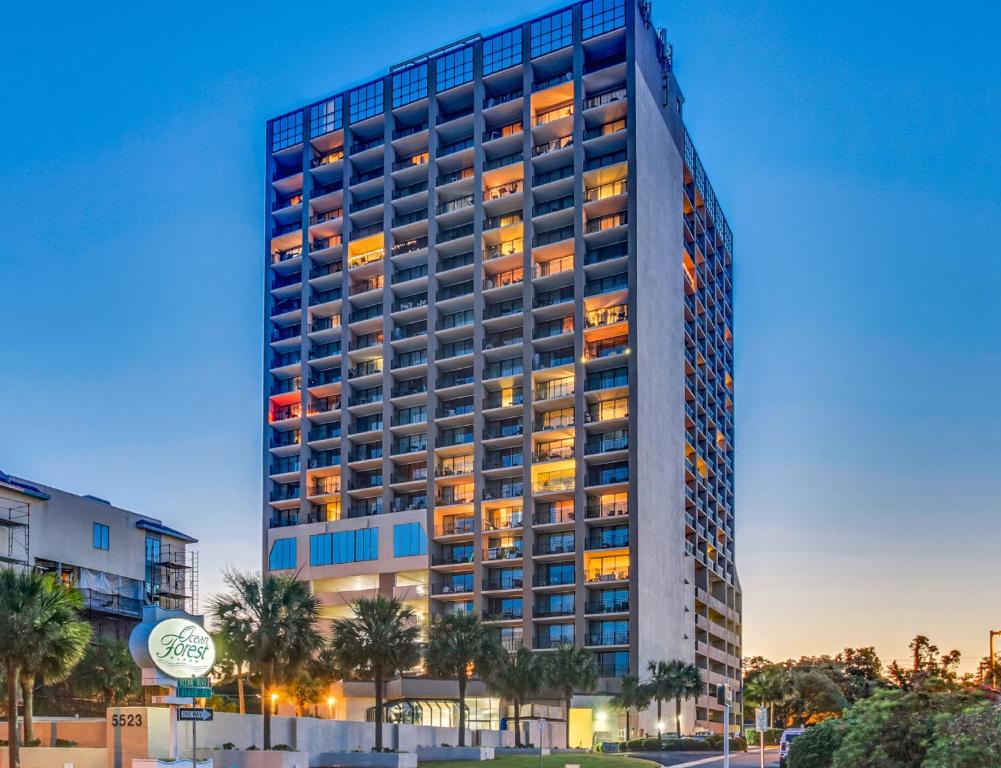 a tall building with its lights on at 2Br Penthouse in the Ocean Forest Plaza in Myrtle Beach